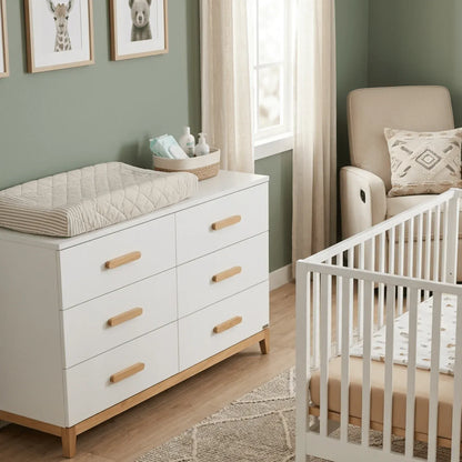 Dadada white six drawer dresser with wooden handles and changing pad in nursery