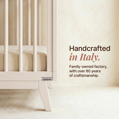 Dadada crib side view with text stating handcrafted in Italy by a family owned factory with 80 years of experience