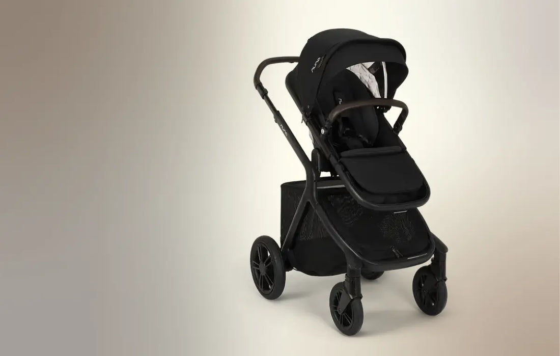 demi icon stroller in caviar against a beige background- new at albee baby!
