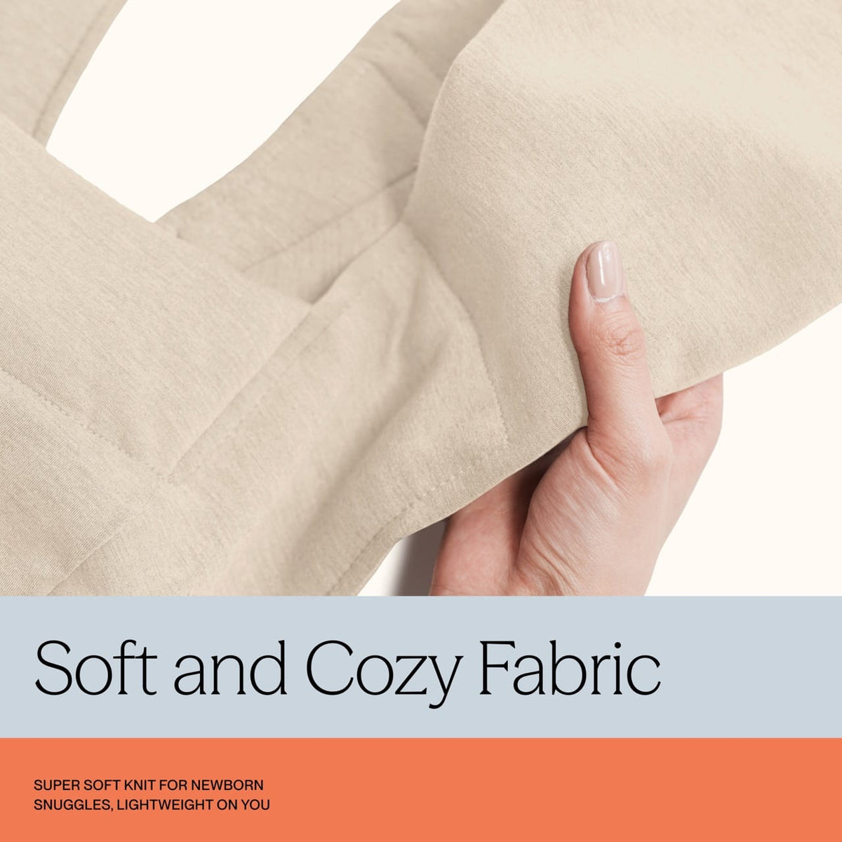 Hand holding beige knit fabric for baby carrier