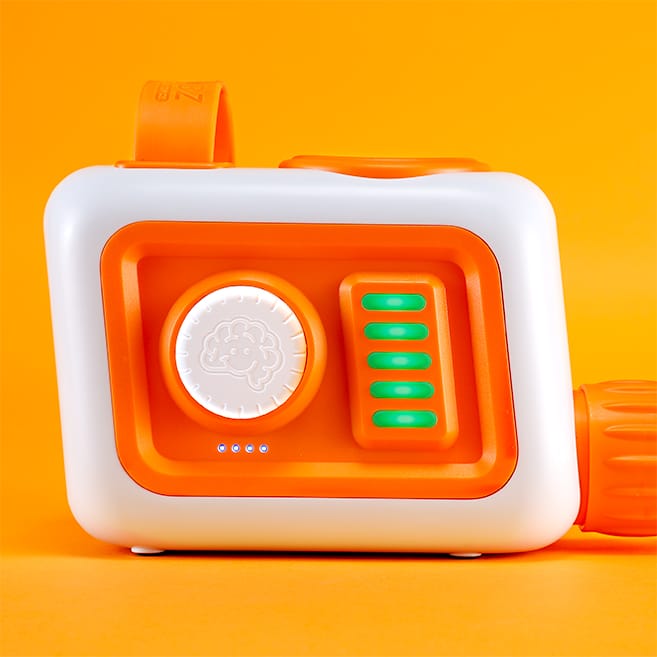 Fat Brain Toys orange and white electronic toy with a central dial and green light indicators