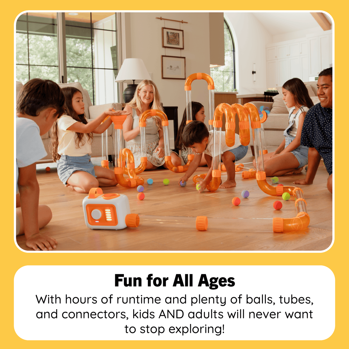 Family playing with Fat Brain Toys marble run set on living room floor