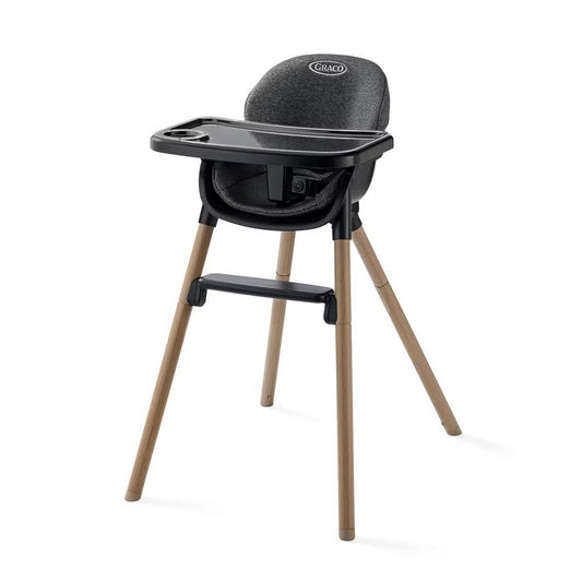 Graco high chair with black seat and tray on light wood legs