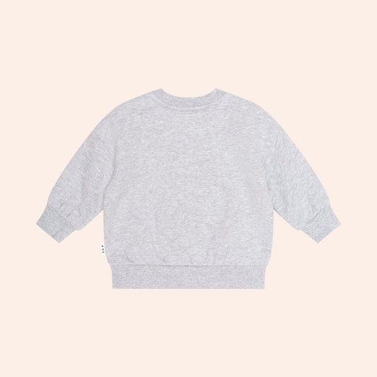 Grey Huxbaby sweatshirt with a brown fuzzy bear face patch