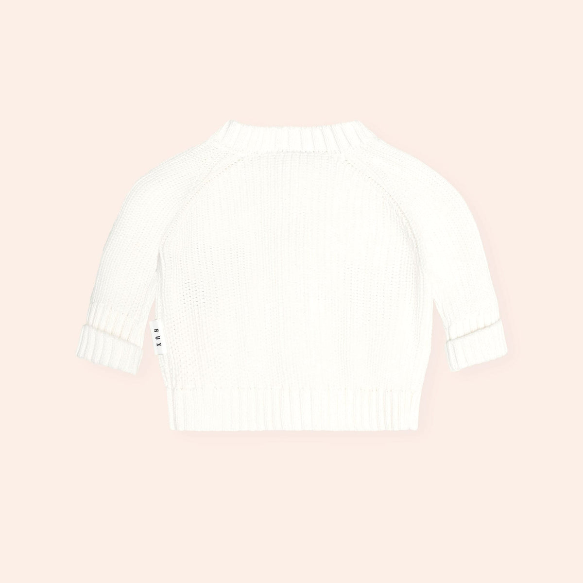 White Huxbaby long sleeve knit sweater with ribbed cuffs and hem