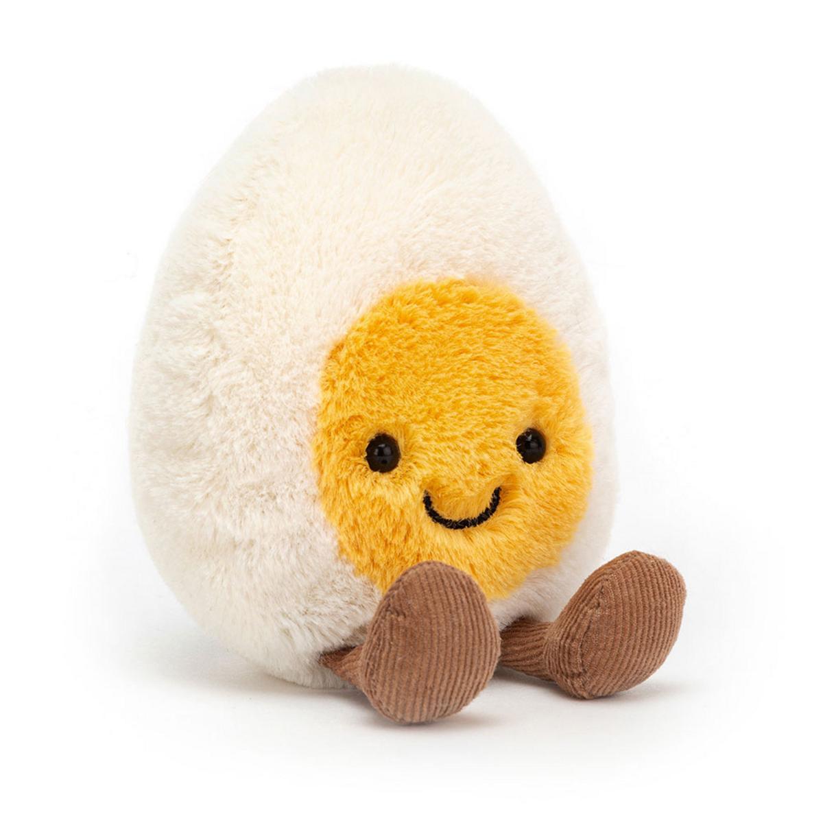 Jellycat plush toy shaped like a boiled egg with a yellow center and brown corduroy feet
