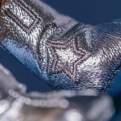 Close up of silver metallic boot material with embroidered star detail