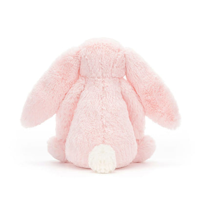 Back view of a Jellycat pink plush bunny with long ears and a white tail