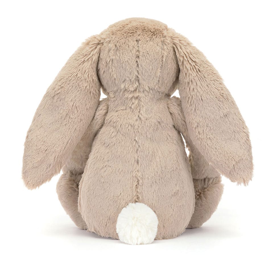 Back view of a beige Jellycat plush bunny with long ears and a white tail