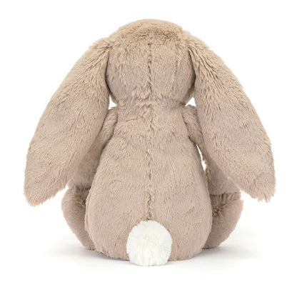 Back view of a beige Jellycat plush bunny with long ears and a white tail