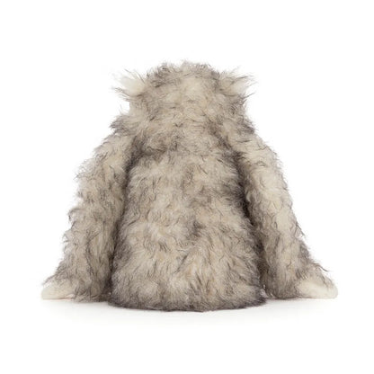 Back view of a Jellycat plush toy with long shaggy cream and grey fur