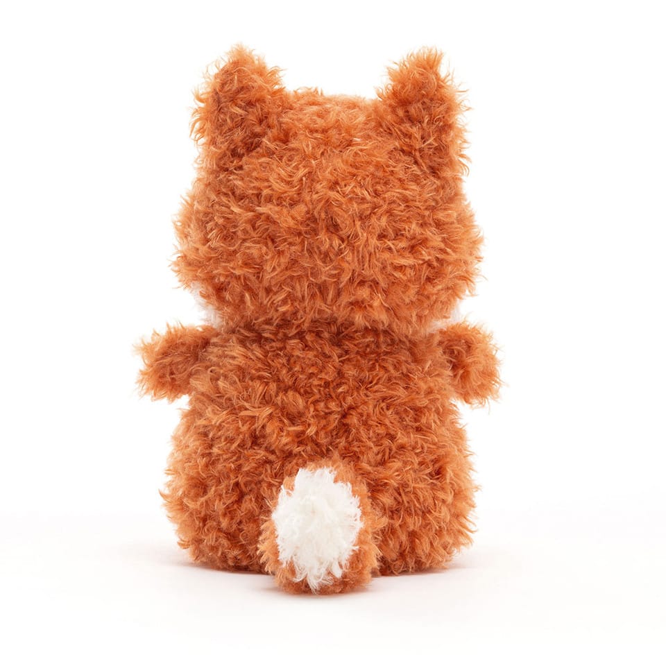 Back view of a Jellycat plush fox with orange fur and a white tail tip