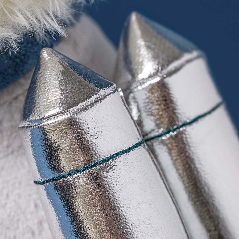 Close up of metallic silver toggle fasteners on a winter coat