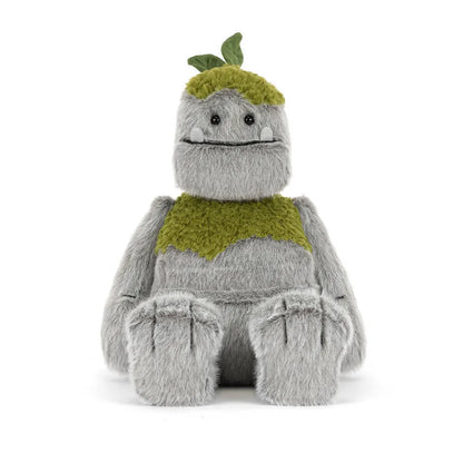 Jellycat grey rock monster plush toy with green mossy patches and two small leaves on top