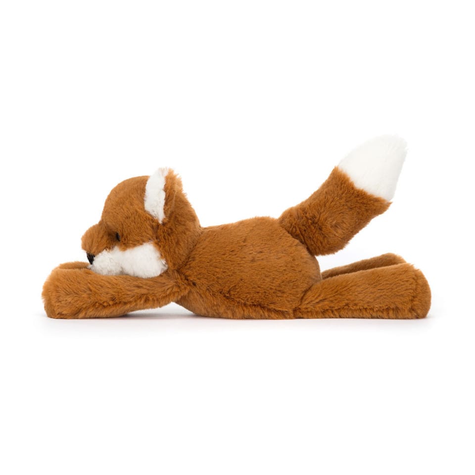 Brown and white plush fox toy lying down