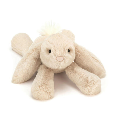 Beige Jellycat plush bunny with long ears and a fluffy white tail
