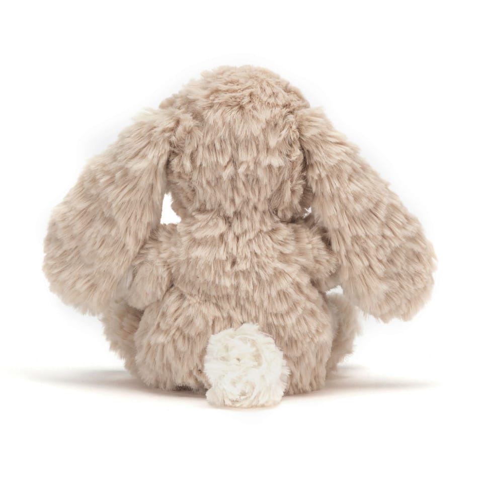 Back view of a beige Jellycat Bashful Bunny plush toy with long ears and a white tail