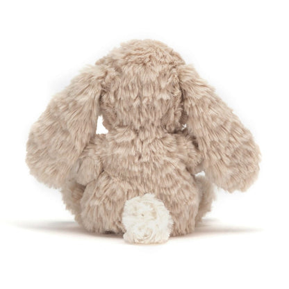 Back view of a beige Jellycat Bashful Bunny plush toy with long ears and a white tail