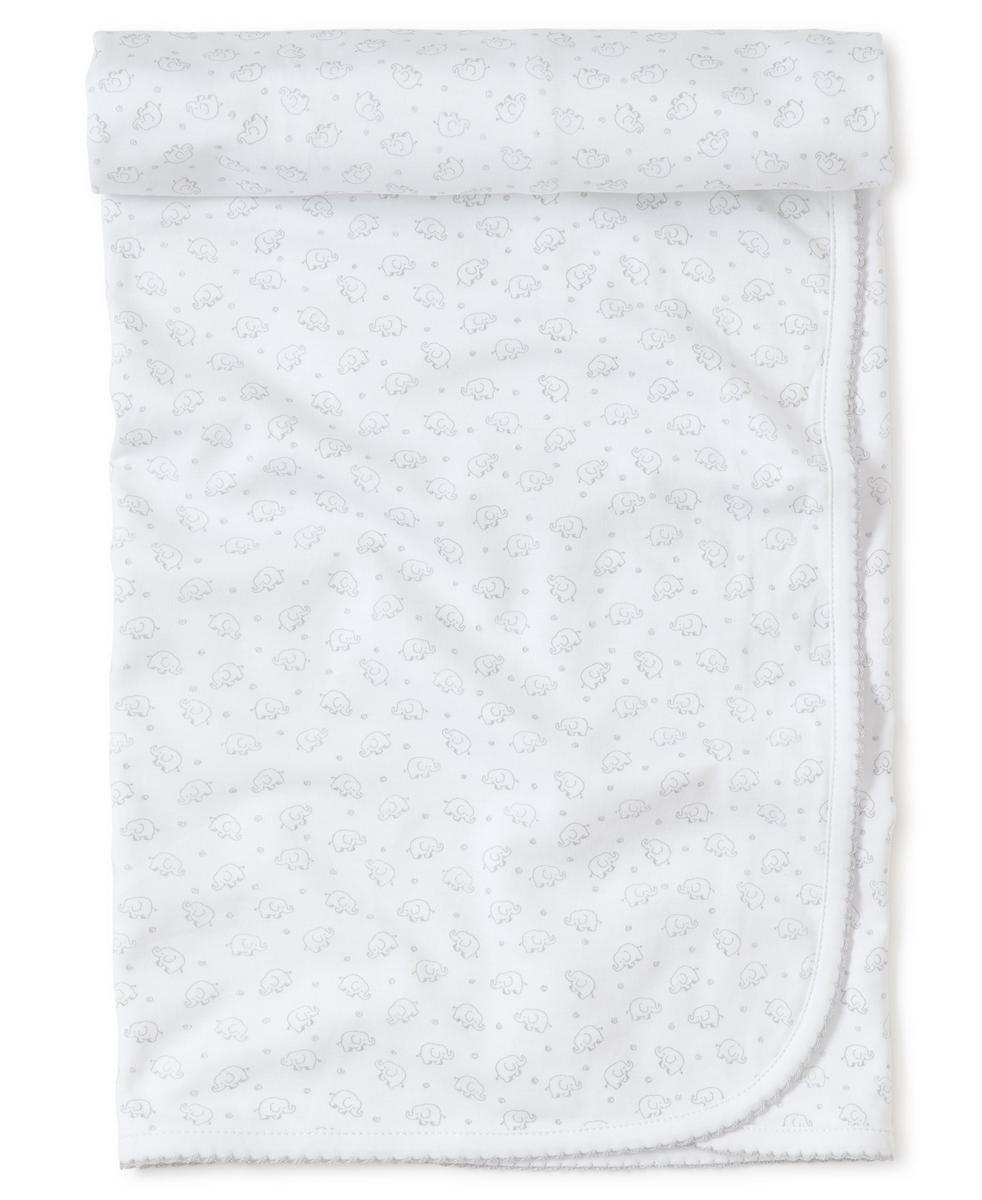 White Kissy Kissy baby blanket with grey elephant pattern and scalloped trim