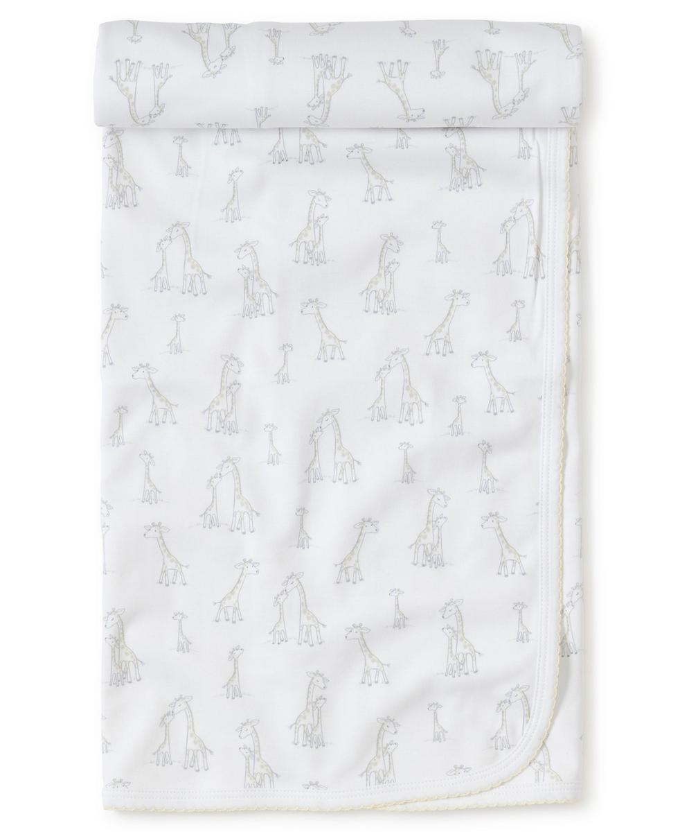 Kissy Kissy white baby blanket with grey and yellow giraffe print