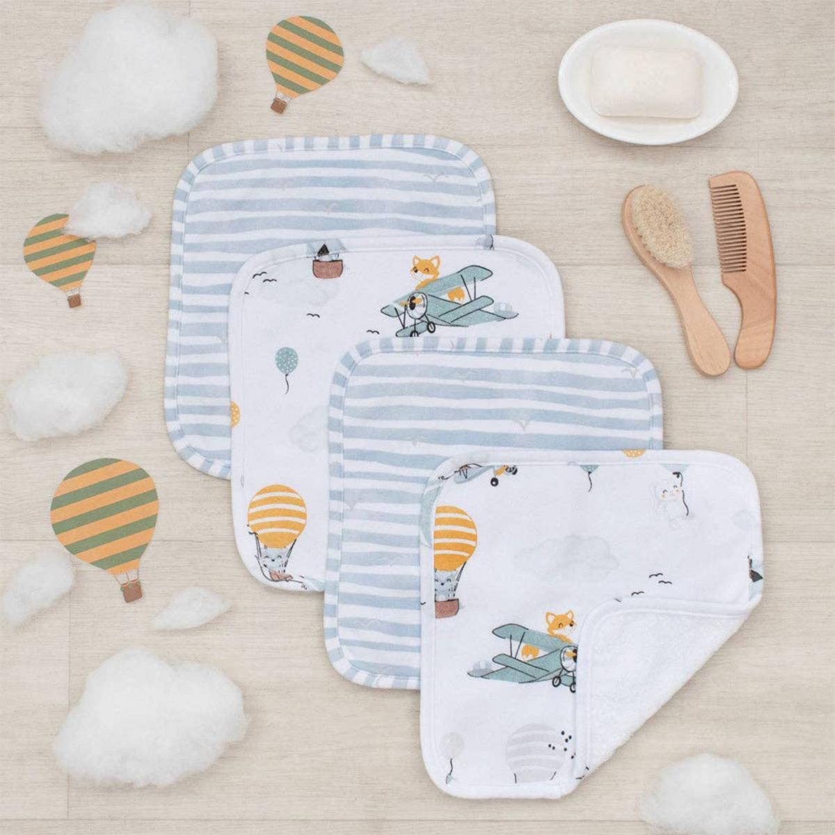 Living Textiles washcloth set with blue stripes and animal aviator prints on a wooden surface with baby accessories