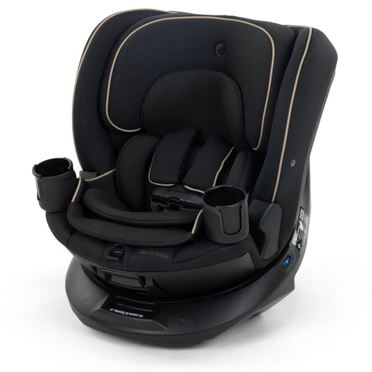 Black convertible car seat with beige stitching and dual cup holders by Maxi-Cosi, side view with rotating base and padded headrest