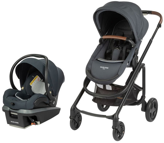 Graphite Maxi-Cosi travel system with infant car seat and stroller, featuring black frame, brown leatherette handle, and mesh storage basket, side view
