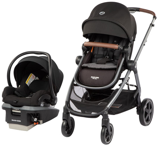 Essential black 5-in-1 modular travel system by Maxi-Cosi, featuring stroller with brown leatherette handle and infant car seat with base, side view display