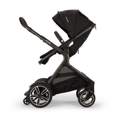 Black Nuna stroller with canopy and storage basket on white background