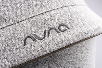 Nuna logo embroidered on light grey textured fabric