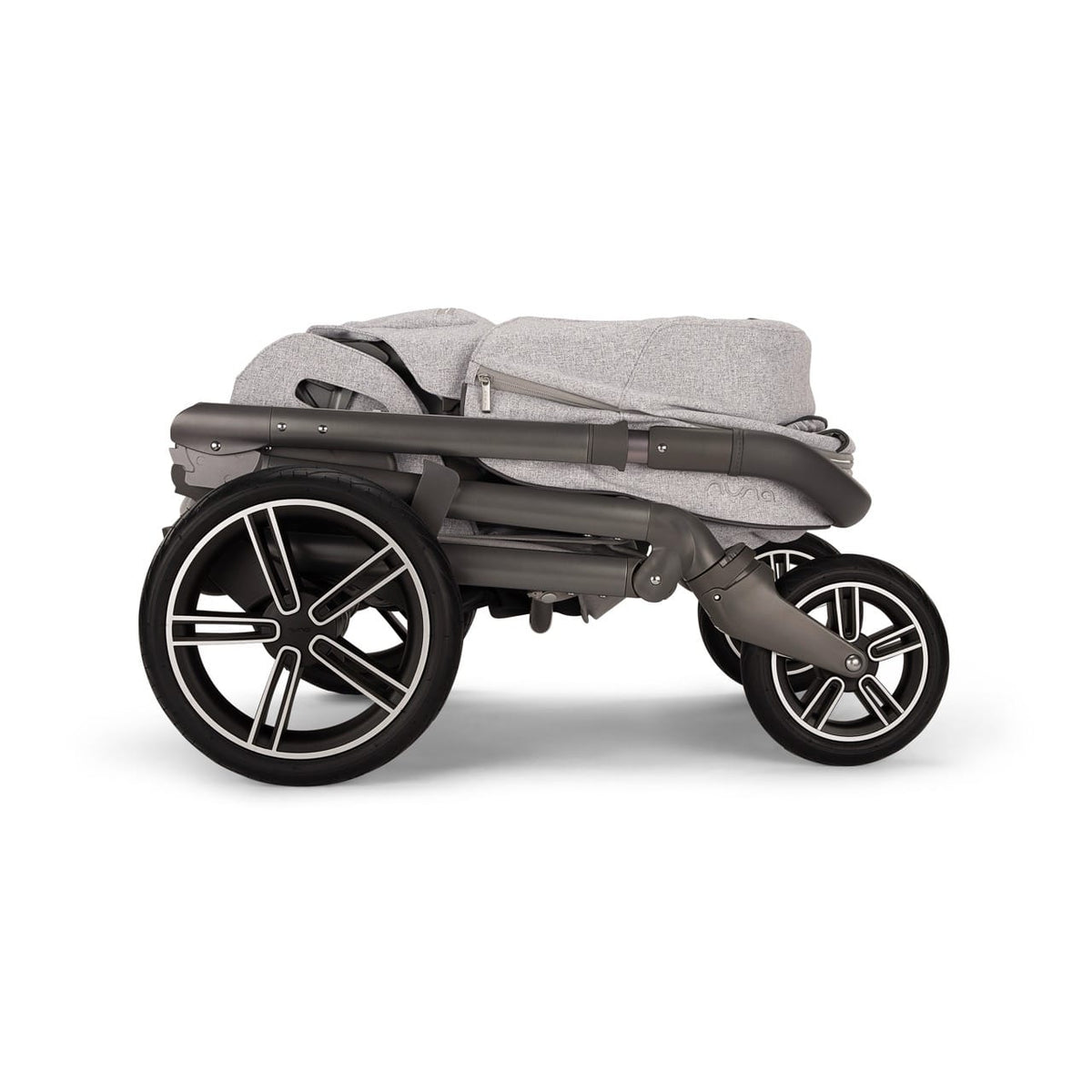 Folded Nuna stroller in grey fabric with dark grey frame