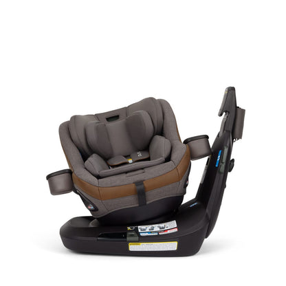 Nuna rotating car seat with brown and grey fabric on a black base
