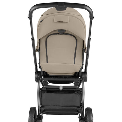PEG stroller with beige canopy and black frame viewed from behind