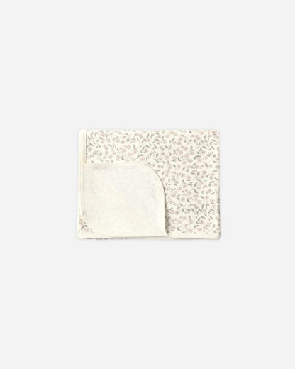 Quincy Mae folded baby blanket with pink floral print on cream background