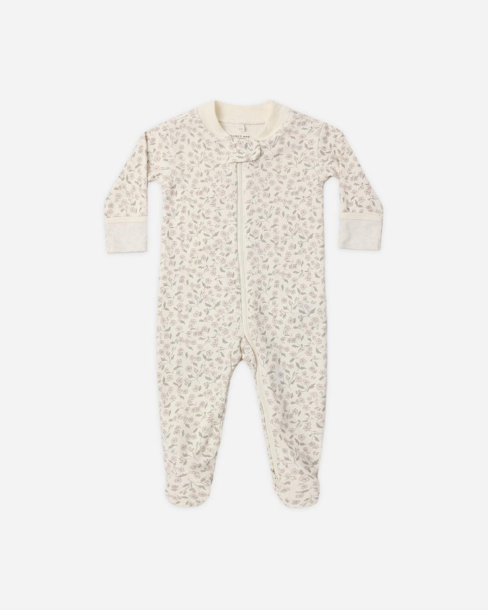 Quincy Mae footed sleeper in cream with a small floral print and front zipper closure