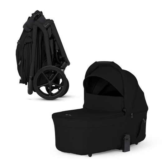 Onyx compact bassinet by Silver Cross, sleek black fabric, side view, with folded stroller frame and large wheels visible.