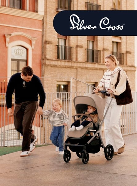 A family strolls on a sunny day. A man holds a child's hand while a woman pushes a baby stroller. "Silver Cross" text is visible.