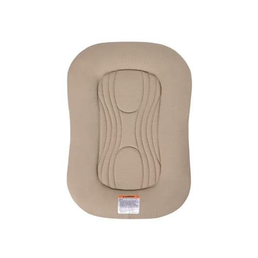 Snuggle Me infant lounger in beige with central quilted padding and safety warning label