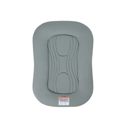 Sage green Snuggle Me infant lounger with central quilted pad and safety warning label
