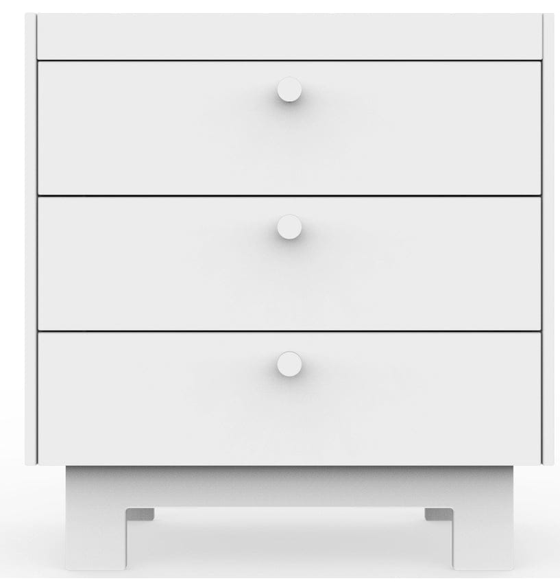 A white three-drawer dresser with round knobs