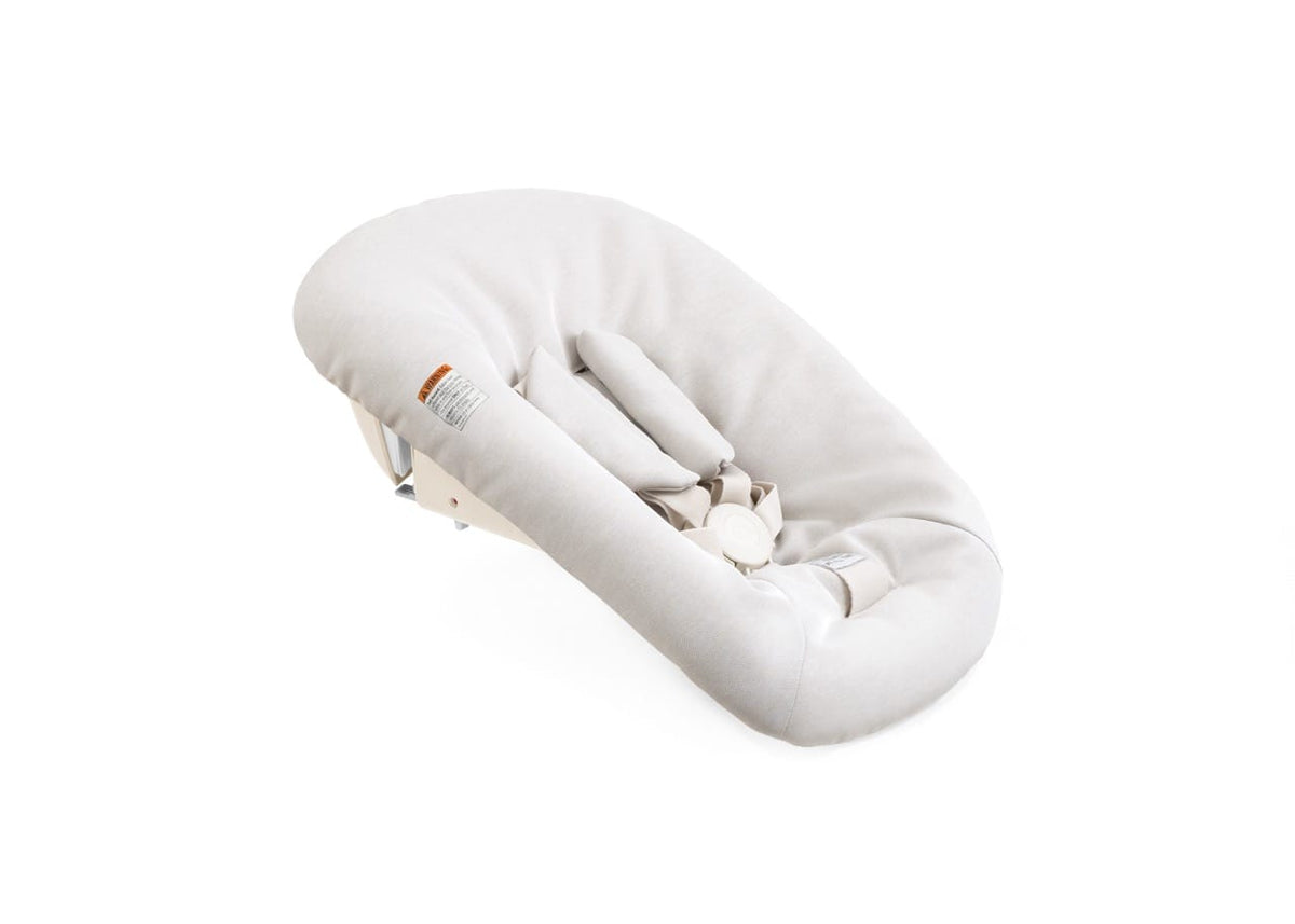 Stokke newborn seat insert in beige fabric with safety harness