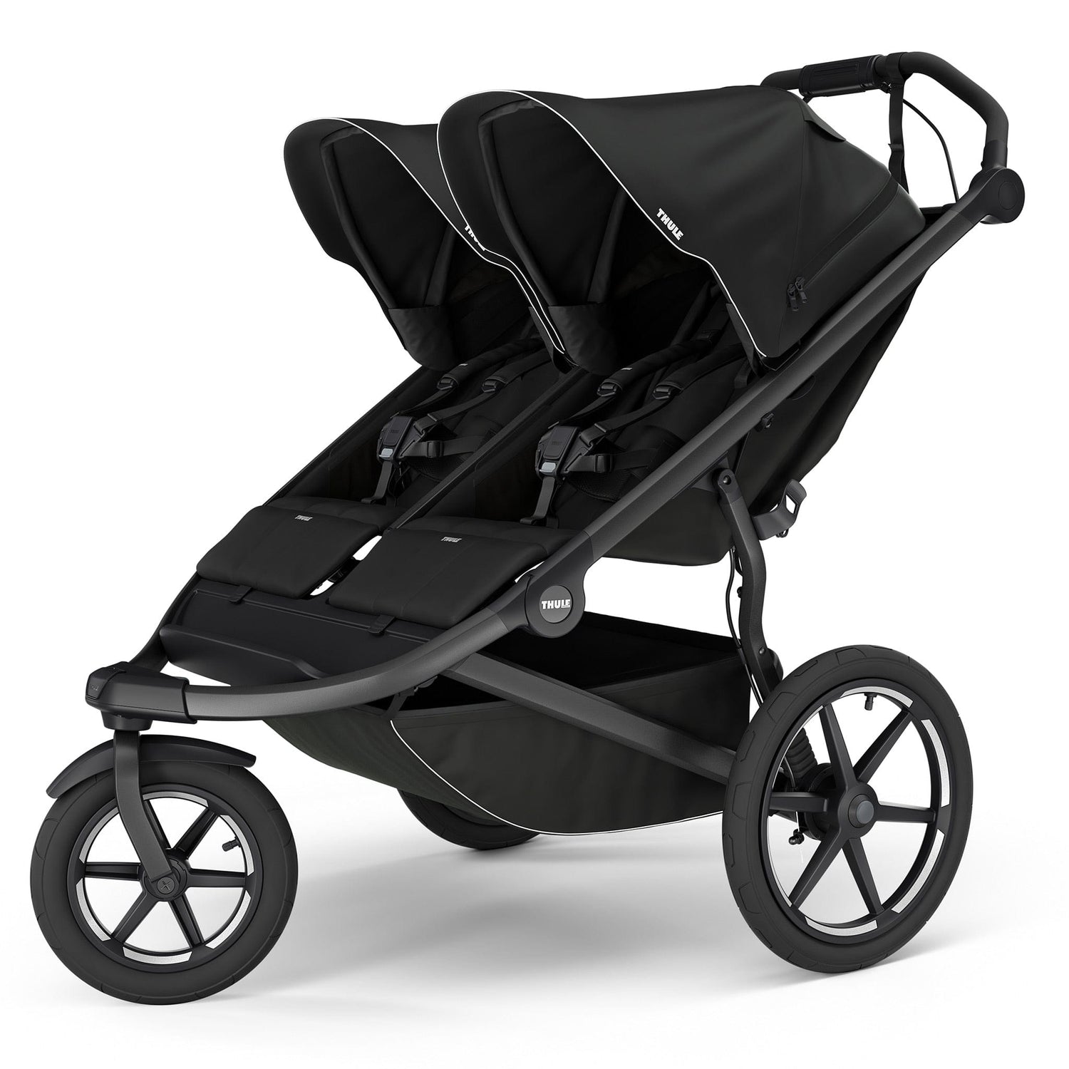 Black double jogging stroller by Thule with magnetic buckle, side view, large all-terrain wheels, padded seats, and white trim accents