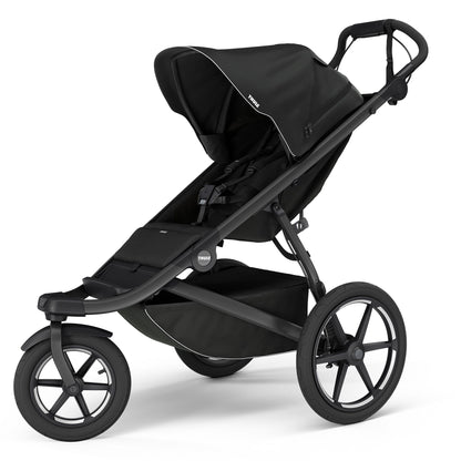 Black single jogging stroller by Thule with magnetic buckle, large all-terrain wheels, and adjustable canopy, side view