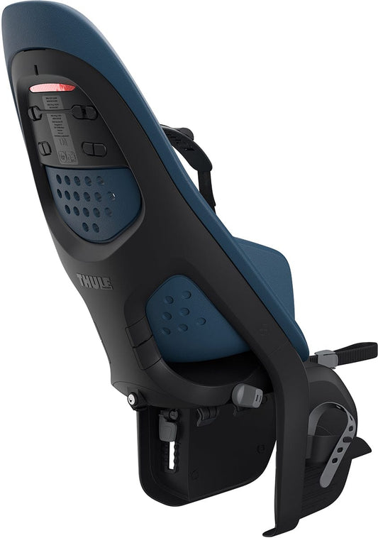Majolica blue rack-mounted child bike seat by Thule, featuring perforated backrest, black harness, and side-mounted footrest, shown in side view.