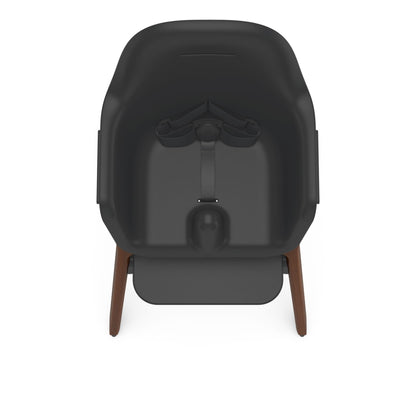 Uppababy high chair with black seat and wooden legs viewed from above