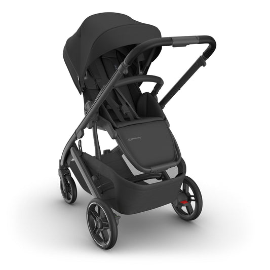 Charcoal Cruz V3 stroller by UPPAbaby with carbon frame, black leather seat, and mesh storage basket, side view