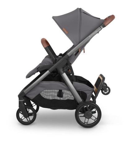 UPPAbaby grey stroller with leather accents and attached ride along board