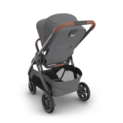 Rear view of grey UPPAbaby stroller with brown leather handle and storage basket