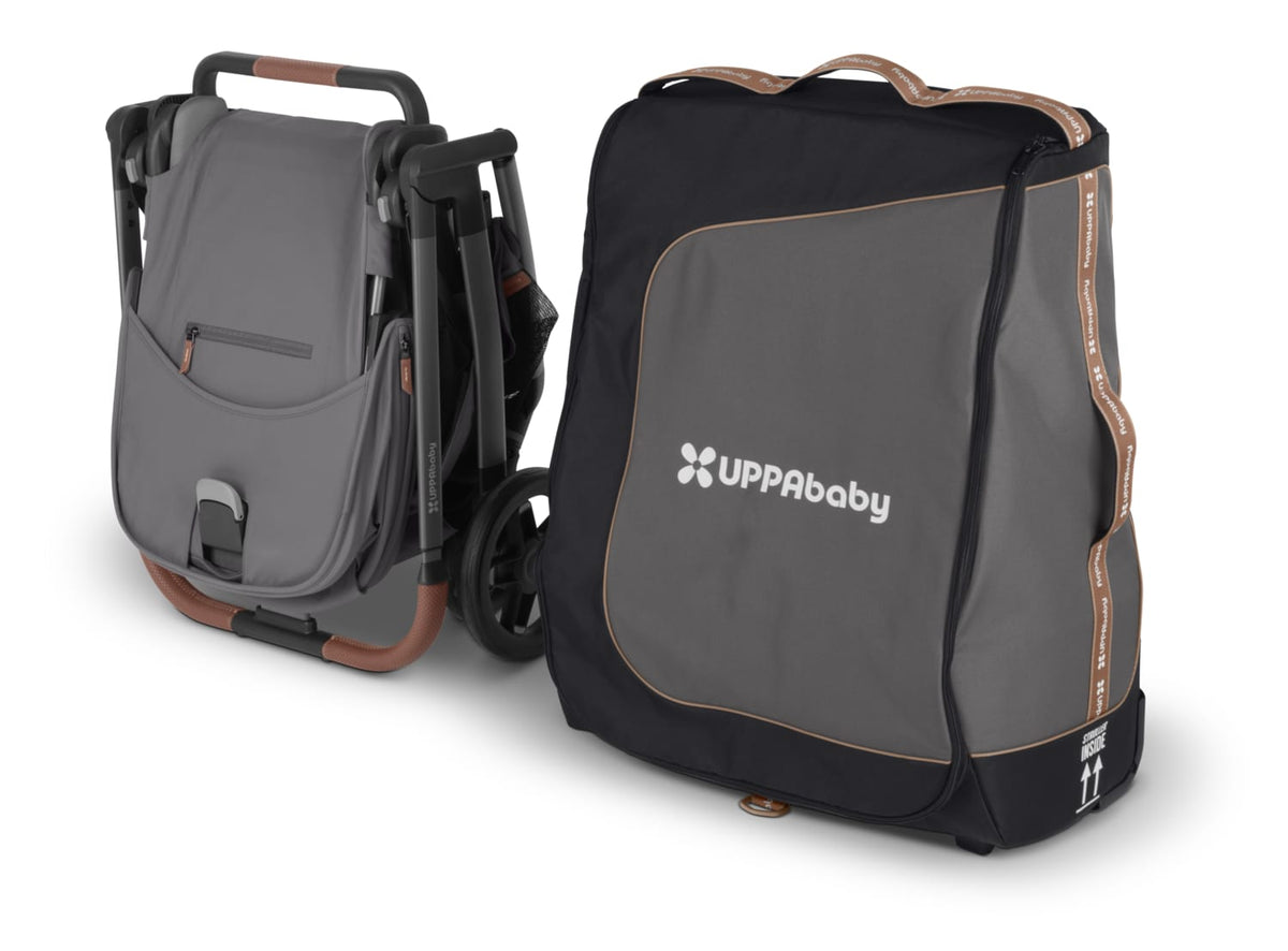 UPPAbaby folded stroller next to a grey and black travel bag