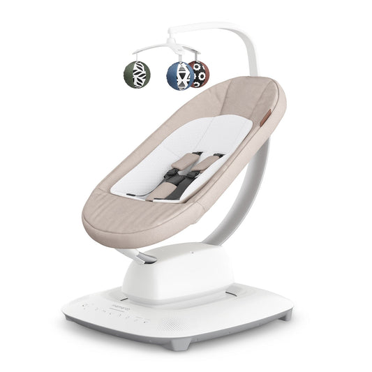 Sand melange multi-motion baby swing by UPPAbaby with white base, patterned hanging toys, and side view angle